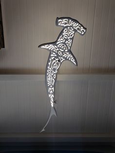 a decorative metal sign hanging from the ceiling