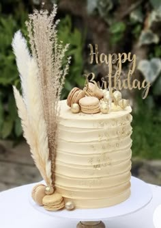 a birthday cake decorated with feathers and shells