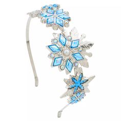 a blue and white headband with snowflakes on the side, attached to a hair clip