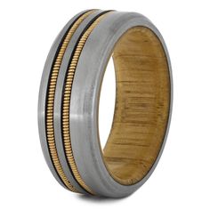 a wedding band with gold and black inlays on the inside, made out of wood