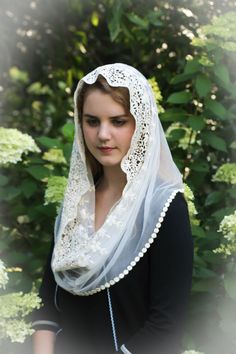 a woman wearing a white veil and black dress