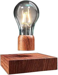 a light bulb sitting on top of a wooden block