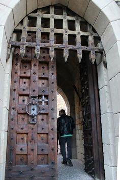 a man standing in front of a wooden door