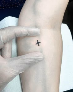 a person with a small tattoo on their arm