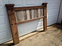 a wooden bench sitting in front of a garage door