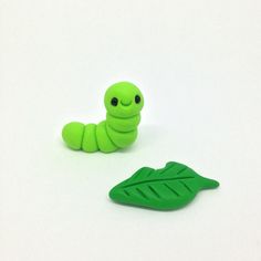 a small green toy with a leaf on the bottom and a smaller one in the middle