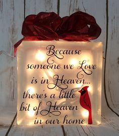 a lighted box with a cardinal on it that says because someone we love is in heaven there's a little bit of heaven in our home