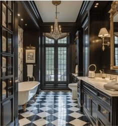 a bathroom with black and white checkered flooring, chandelier, double sinks, and tub