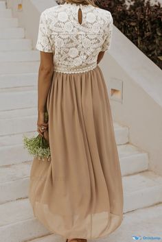 a woman in a dress is walking down the stairs with her hand on her hip