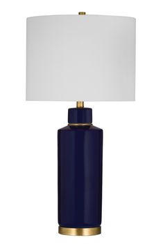 a blue table lamp with a white shade on the top and gold trim around the base