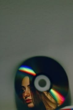 a blurry image of a woman's face in front of a cd disc