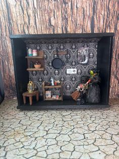 a doll house with shelves and decorations on the wall