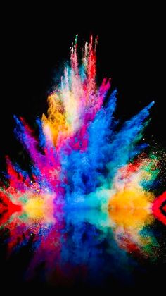 colorful powder exploding in the air on a black background