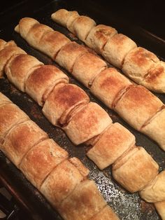 bread sticks are lined up on a baking sheet