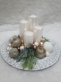 a white plate topped with candles and ornaments