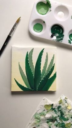 the paint is being used to create an art project with succulents and leaves