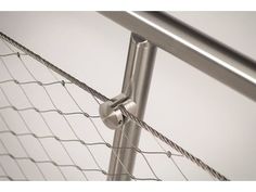 a close up view of a metal fence with a ball and chain attached to it