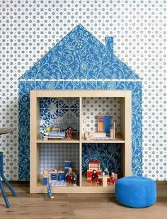 a doll house with blue walls and furniture