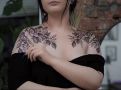 a woman with tattoos on her chest and arms