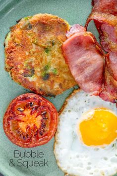 an egg, bacon and tomato breakfast on a plate with the words bubble & squeak