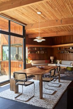 the dining room table and bench are both made out of wood, with chairs around it