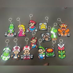 the nintendo keychains are all made out of pixel video game character images and characters