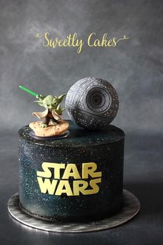 a star wars themed cake with a toy on top