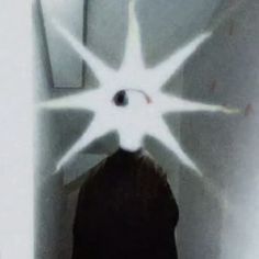 a woman standing in the corner of a room with an upside down star on her head