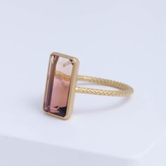 Description One-of-kind 18k yellow gold ring with an earthy brown and pink bi-color Tourmaline set in a vertical setting. The pink and brown is a perfect balance to create the perfect feminine color that's not too cute or too sweet, like a glass of Portes you drink next to your fire place. This ring is in a rope design, adding detail to every part of the ring. Details 18k Yellow GoldBi-color Tourmaline – 5.97ct (Approximately 7.6mm x 12.1mm x 5.7mm) Made in Japan *Please note that due to the nat Polished Tourmaline Rings, Unique Pink Tourmaline Rings, Pink Tourmaline Yellow Gold Ring, Luxury Pink Tourmaline Rings, Pink Tourmaline Cabochon Ring, Brown And Pink, Earthy Brown, Pink And Brown, Rope Design