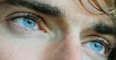 a close up of a person with blue eyes