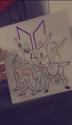 a person holding up a drawing with people on it