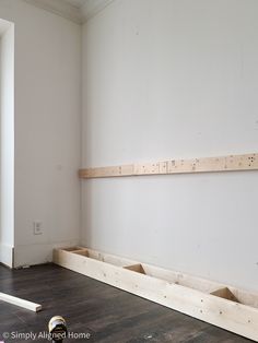 an empty room with some wooden planks on the floor