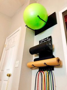 an exercise ball and gym equipment hanging on the wall