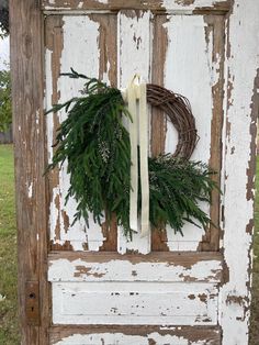 a wreath is hanging on an old door