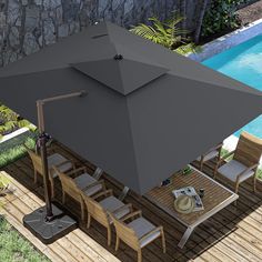 an overhead view of a patio table and umbrella next to a swimming pool with a stone wall in the background