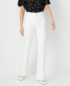 Elevate your wardrobe with the Ann Taylor Mid Rise Boot Jeans, a perfect blend of comfort and chic style. These jeans are meticulously designed to flatter your figure, featuring innovative pockets that smooth and maintain their shape throughout the day.

- **Size:** 14
- **Color:** White
- **Material:** 98% Cotton, 2% Elastane
- **Gender:** Female
- **Fit:** Relaxed and easy
- **Rise:** Mid rise, sits 2 1/4" below natural waist
- **Leg Shape:** Bootcut, sleek with a slight kick at the hem
- **Le White Bootcut Jeans, Size 16 Women, Size 12 Women, Knitted Suit, Taylor White, Style Steal, Size 10 Women, Boot Jeans, Tall Jeans