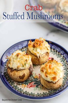 three stuffed mushrooms on a plate with the title crab stuffed mushrooms in the middle,