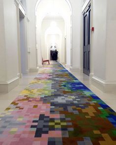 the hallway is decorated with multicolored rugs