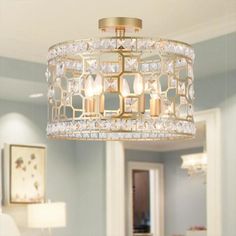 a chandelier hanging from the ceiling in a living room