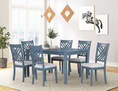 a dining room table with six chairs and a rug