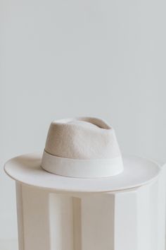 I am THE showstopper. Wear me around town and receive all of the oos and ahs as you perfect your outfit with my white radiance. I am here to impress. Modern White Hat With Curved Brim, Chic White Hat For Fall, Chic White Fall Hat, Classic White Hat For Fall, Luxury White Hats For Spring, Chic Fitted White Hat, Chic White Fitted Hat, Luxury Fitted White Hat, Wool Fedora