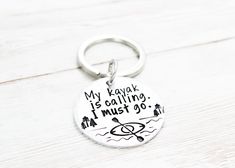 a keychain that says, my kayak is calling i must go