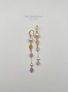 Freshwater pearl and Amethyst Gold, Long ,Statement earrings I have combined the Freshwater Pearls with Light purple Amethyst and a beautiful gold filled connector  Earring drop length is about 8.5 cm Earring Findings are 14k gold filled   Because pearls are a natural product, the colours, patterns and shapes (particularly with baroque pearls) vary from piece to piece. This means your earrings will be completely unique as no two baroque pearls will ever be identical. Pearls are associated with purity, integrity, and the loyalty of their wearer - which explains their continued popularity in wedding jewellery.  Pearls symbolise wisdom. They are believed to attract wealth and luck as well as offer protection Comes gift wrapped ready to give or to keep