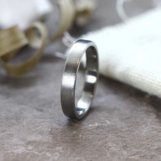 Lightly Brushed / Matte Titanium Ring, a simple and minimalist flat Titanium band. The Grade 5 Titanium used is the same used in the aerospace industry, a very light metal, extremely resistant to corrosion and also hypoallergenic. This titanium alloy is considered the best for creating lightweight yet extremely strong jewelry. This Titanium band can be a perfect 5th year anniversary gift or engagement ring, wedding band for men and for women too. * SIZING * All my rings are made to order to ensu Mountain Range Ring, Modern Mens Rings, Titanium Rings For Men, Gray Ring, Damascus Steel Ring, Minimalist Flat, Wood Wedding Ring, Promise Rings For Guys, Wood Wedding Band