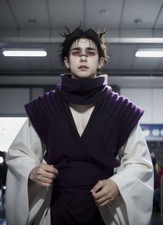 a man with black hair wearing a purple outfit