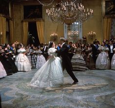 a bride and groom dance in front of an audience