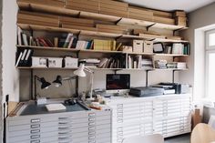 an office with lots of shelves and drawers