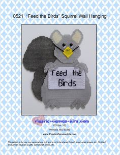 a bird is holding a sign with the words feed the birds in it's beak