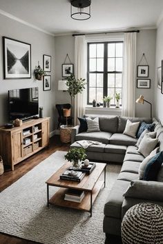 a living room filled with furniture and a flat screen tv on top of a wooden table