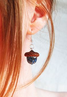 a close up of a person wearing some kind of earring with something in it